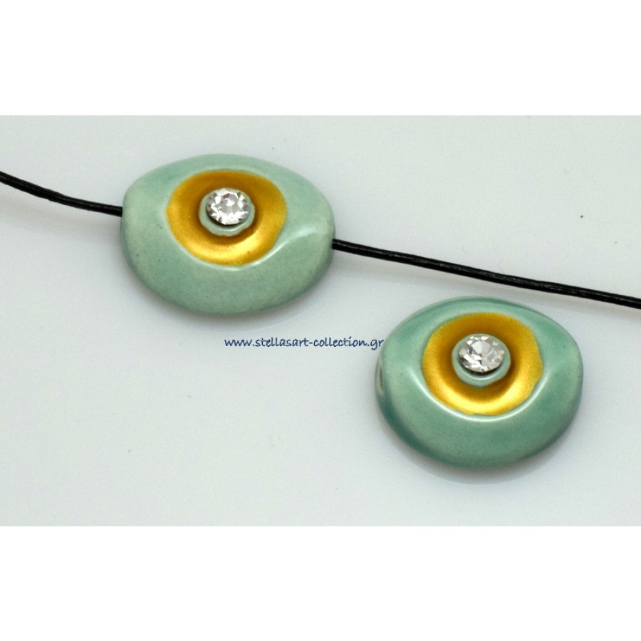 Κεραμικό μάτι 21x18mm ΜΕΣΑΊΟ με οριζόντια τρυπα (Ø2.2mm)βεραμαν με χρυσό σμάλτο εξαιρετικής ποιότητας και λευκο στρας στο κέντρο     τιμή ανα τεμάχιο