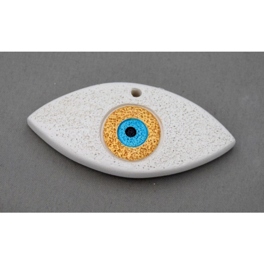 Μεσαίο  κεραμικό μοτίφ μάτι 6,8X3.5cm σε μπέζ χρώμα με τρύπα στην πάνω μεριά. Ανα τεμάχιο